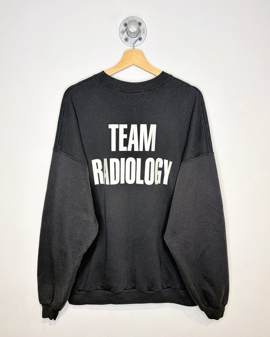 Vintage 2000s “Here To Scare Because We Care” Team Radiology Faded Black Crewneck Sweatshirt